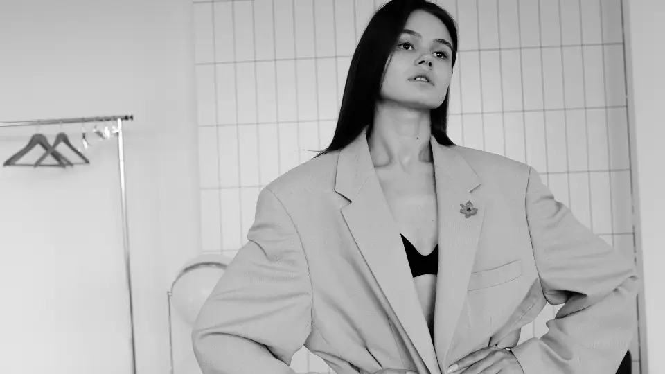 A black and white photo of a woman in a suit jacket.